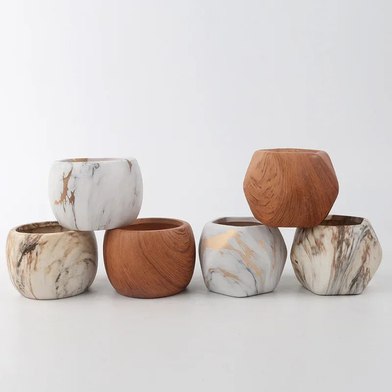 Ceramic succulent pots set in marble white and warm wooden-brown round shapes