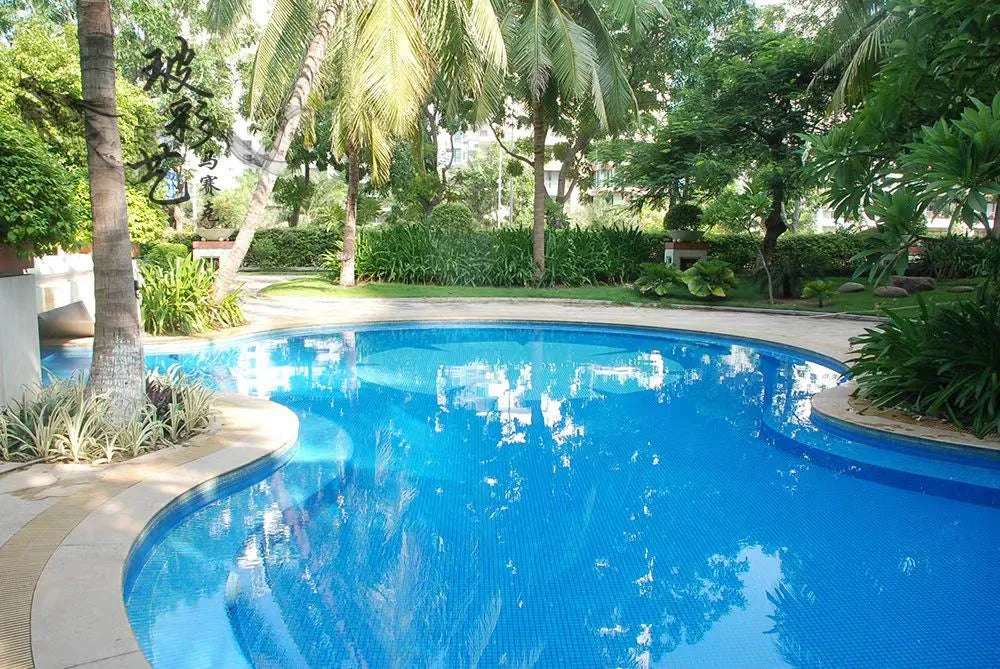 Ceramic mosaic pool tiles in bright blue with small square pattern.