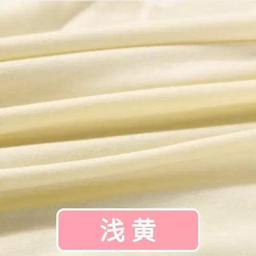 Soft, light yellow organic knit jersey fabric with gentle folds, ideal for baby garments and sewing projects.