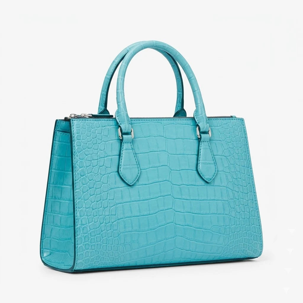 Turquoise blue crocodile-embossed genuine leather designer handbag with dual top handles and silver hardware.