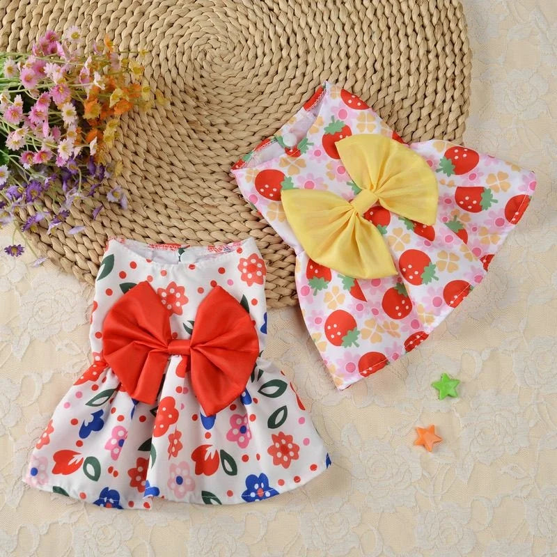 Cute strawberry and floral print puppy dresses with bows for small dogs and kittens. Perfect summer pet apparel.
