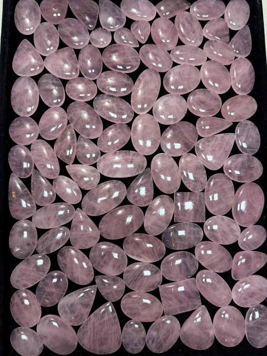 Loose rose quartz cabochon gemstones, pastel pink rounded ovals with high-gloss finish