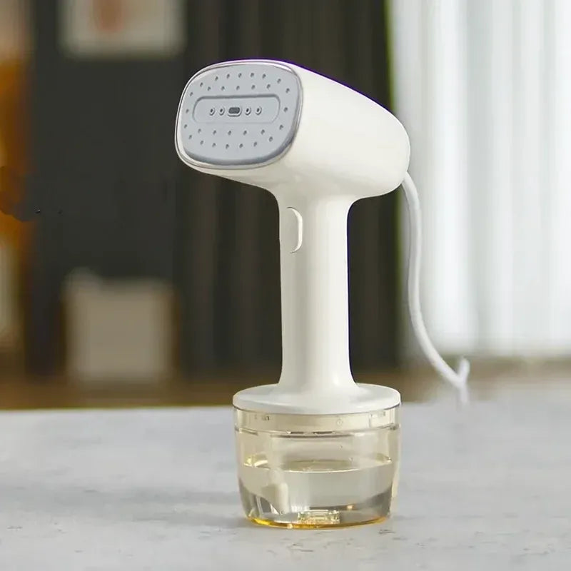Handheld garment steamer in white with clear water tank for quick wrinkle removal.