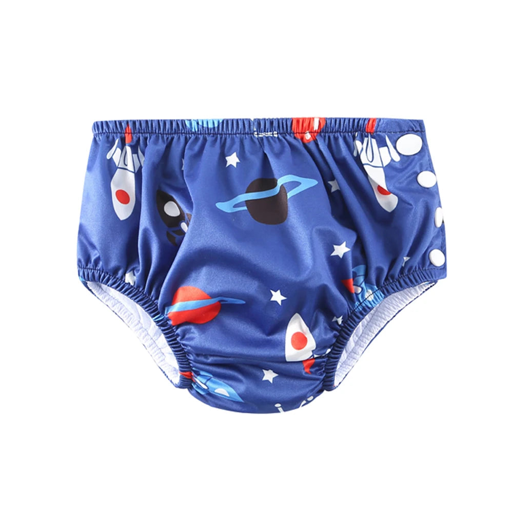 Reusable baby swim diaper in blue with rocket ship and planet print, features side snap closures.