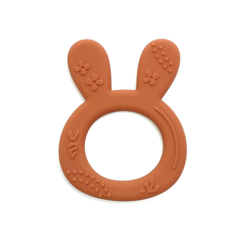 Rust-colored silicone teething ring for baby, bunny-shaped textured sensory toy for soothing teething pain.