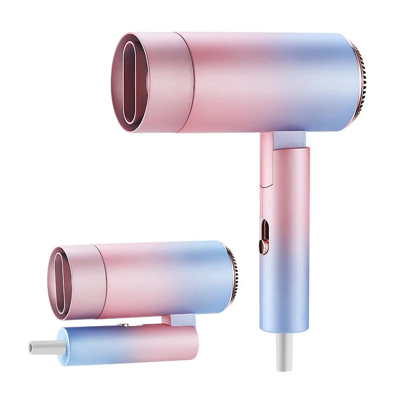 Foldable mini ionic hair dryer in pink-blue gradient with nozzle attachment for fast, quiet drying.