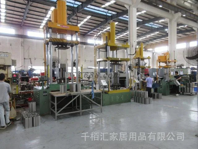 Stainless steel pressure cooker manufacturing line inside a factory workshop