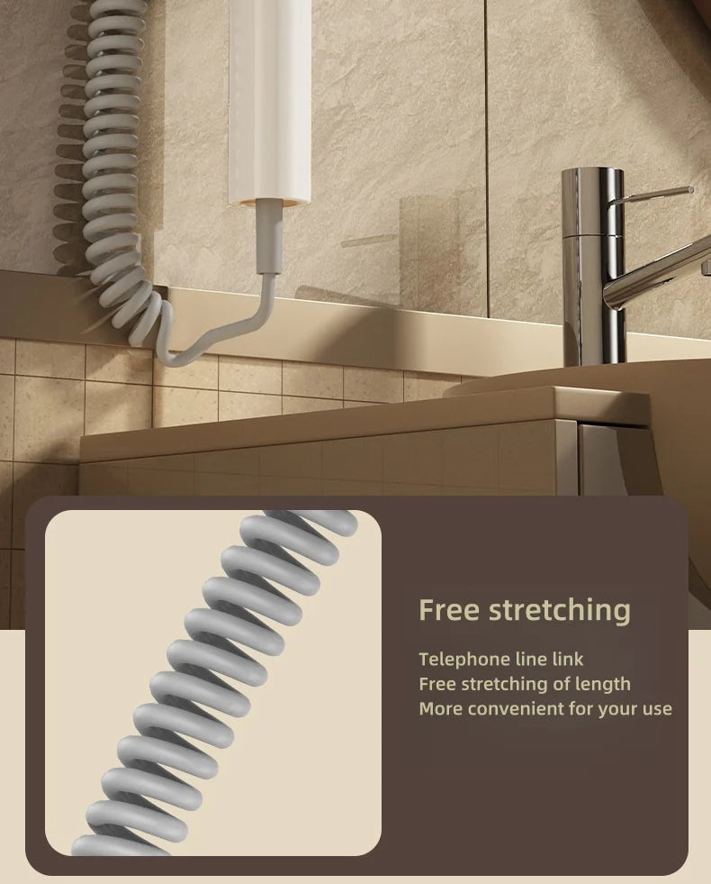 White wall-mounted hair dryer with flexible, extendable telephone-style coiled cord for bathroom convenience.