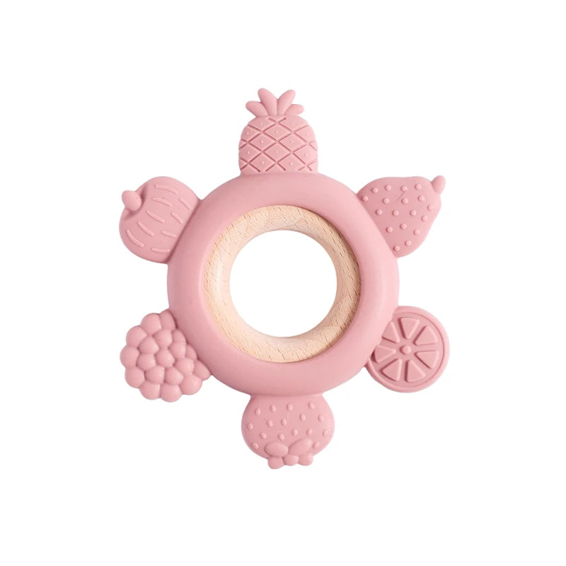 Pink silicone and natural wood fruit baby teething ring for soothing sore gums.