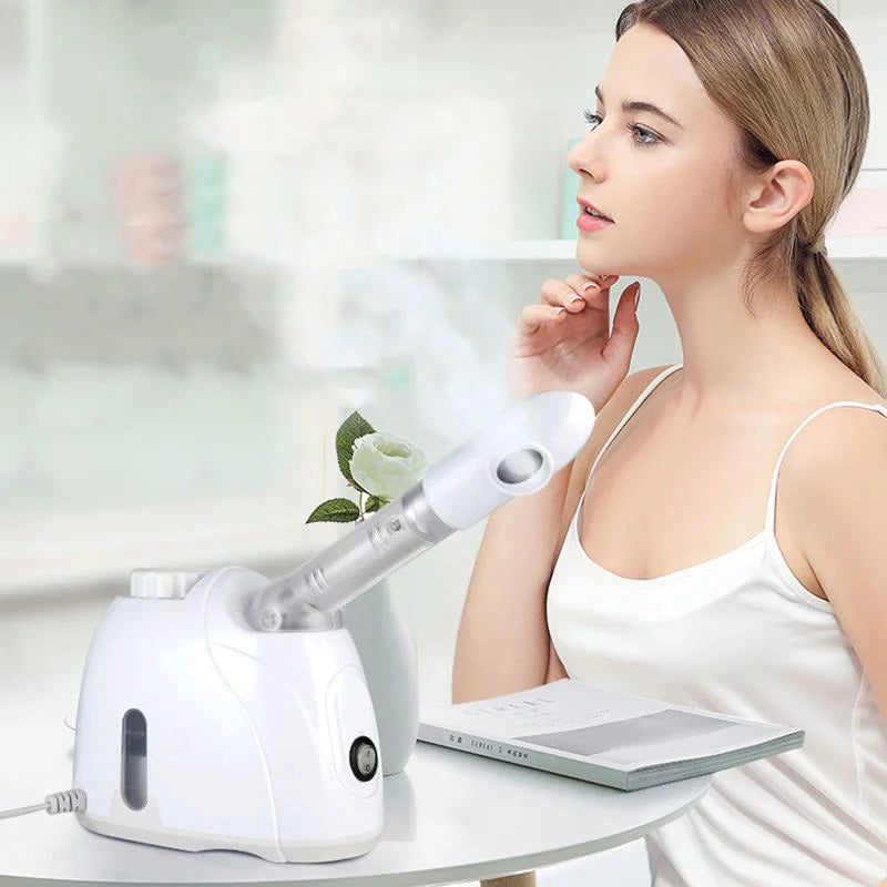 Woman using a white portable nano mist facial steamer for deep pore cleansing and hot spa skin hydration at home.