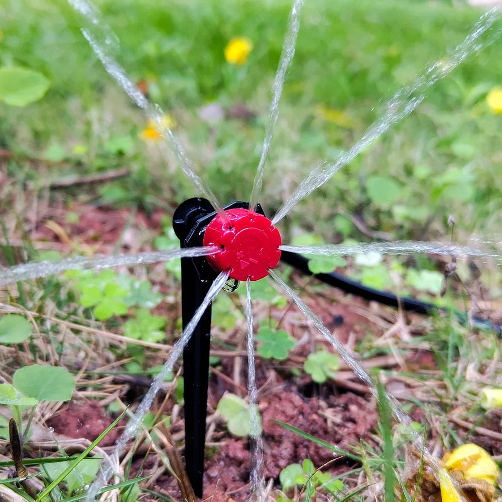 Micro drip irrigation dripper with adjustable nozzle, spraying water onto garden soil