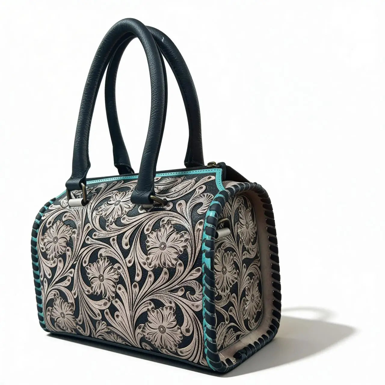 Luxury teal and black genuine leather mini duffel trunk with intricate floral tooling and double handles.