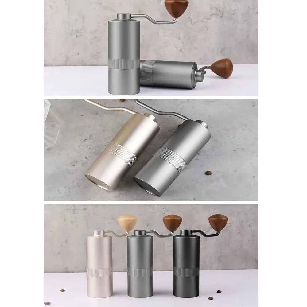Portable manual coffee grinder with wooden knob, stainless steel body, available in silver, grey, and matte black.