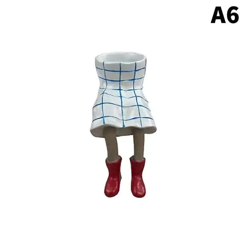 Resin leggy planter figurine with white pot and blue grid lines, red boots