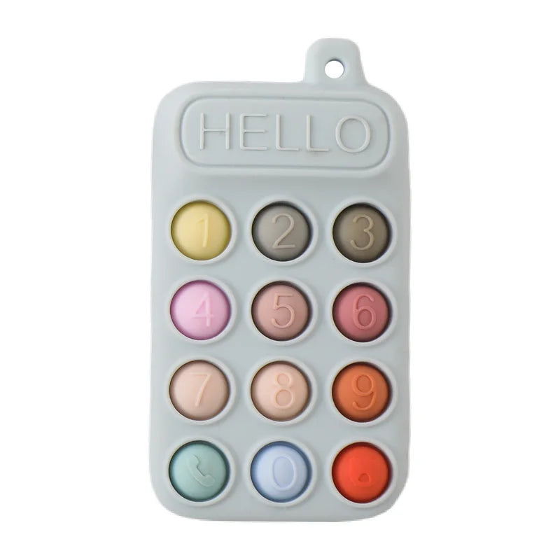 Grey silicone baby teething toy in a phone shape with colorful number buttons for soothing teething relief.
