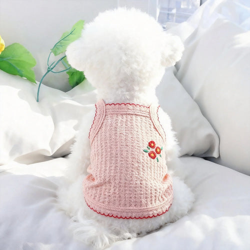 Pink knitted dog dress with thin straps and embroidered flower on front