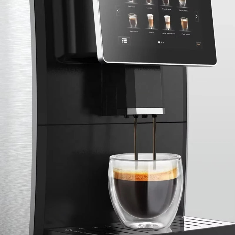 Black and silver touchscreen automatic espresso coffee machine pouring a fresh shot into a clear double-wall glass.
