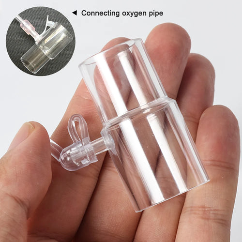 Clear CPAP hose oxygen adapter with port for sleep apnea therapy tubing, held in hand.