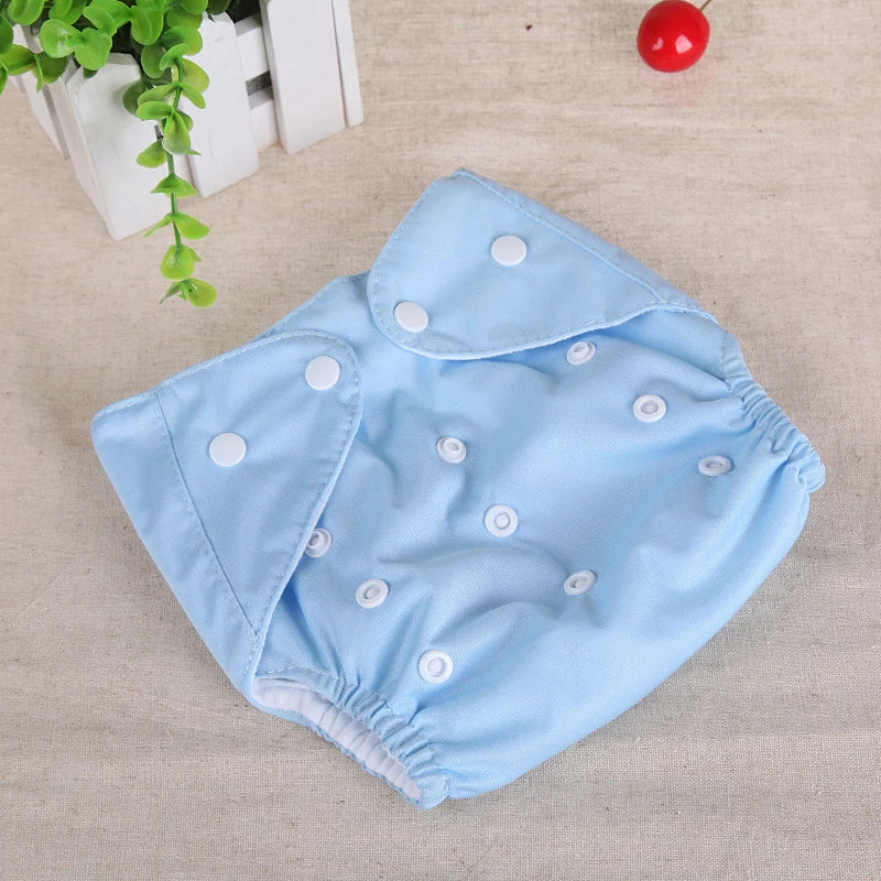 Reusable baby cloth diaper in solid light blue with adjustable white snap buttons for a custom fit.
