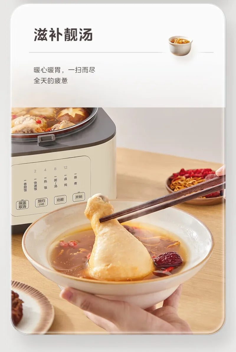 White rice cooker with lid open and inner pot steaming over a bowl of soup.