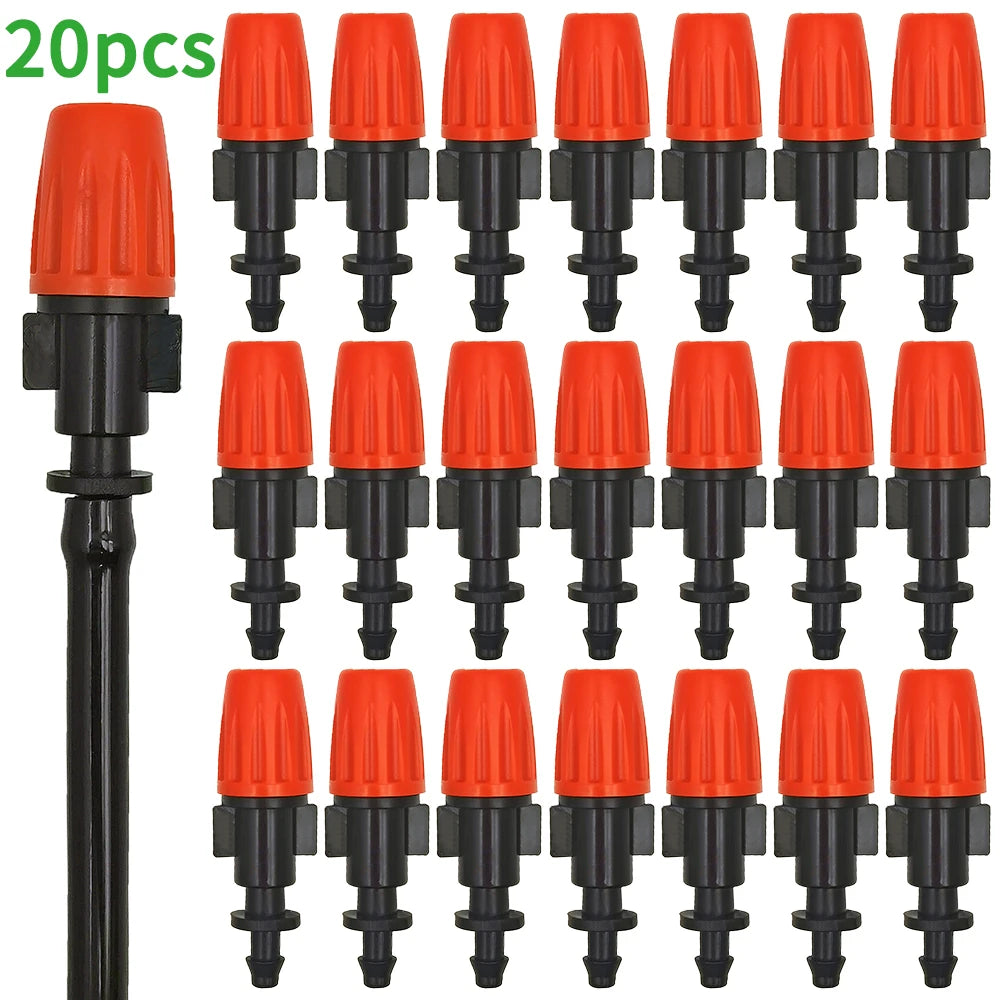 Orange drip irrigation emitters with black fittings, multiple nozzle heads in set