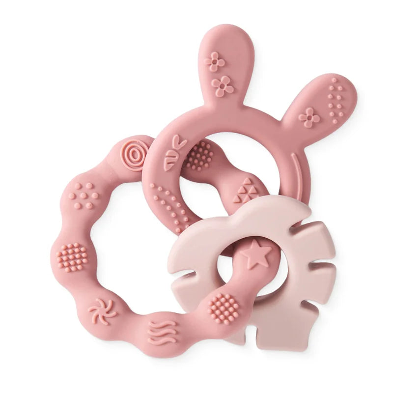 Pink silicone baby teething rings for soothing relief. Durable, BPA-free baby teething toy set in soft pastel colors.