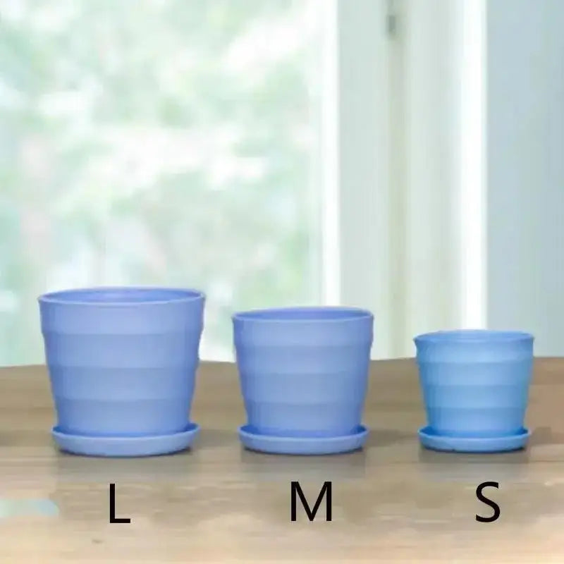 Light blue plastic flower pots in three sizes labeled L, M, and S
