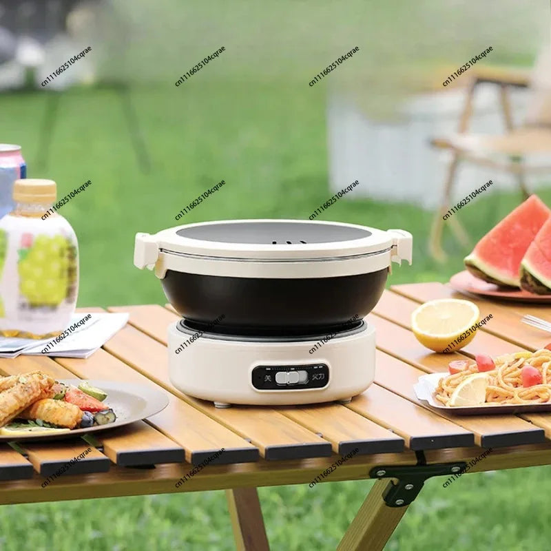 Portable electric rice cooker on white base with black cooking bowl and open lid