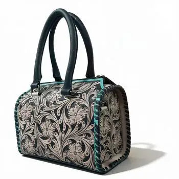 Luxury genuine leather mini duffel trunk with teal heart floral pattern, double handles, and stitched leather trim.