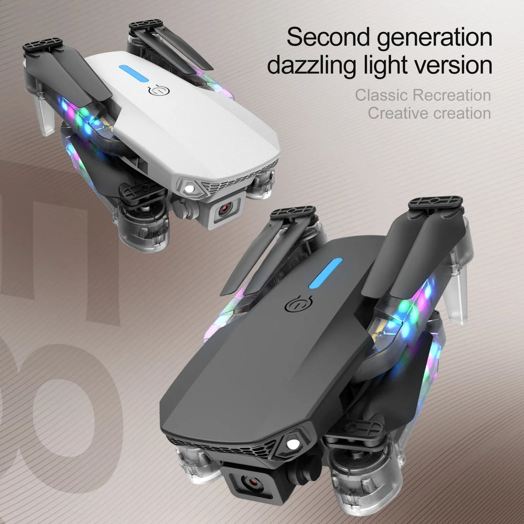 Two foldable camera drones in matte black and white, featuring multi-color LED lights on the arms for recreational use.