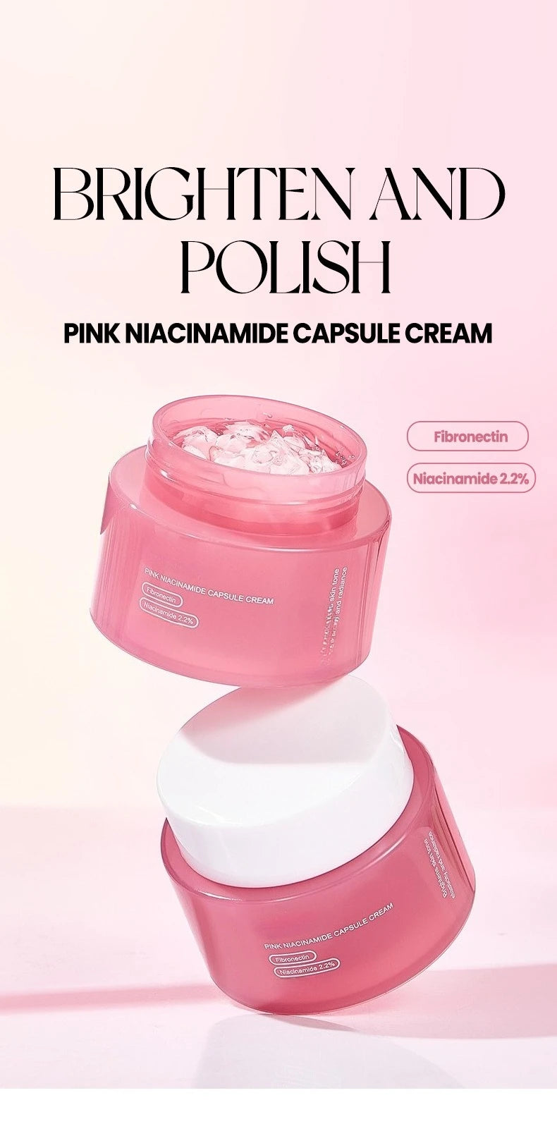Two jars of pink capsule face cream with white lids stacked against a soft pink background.