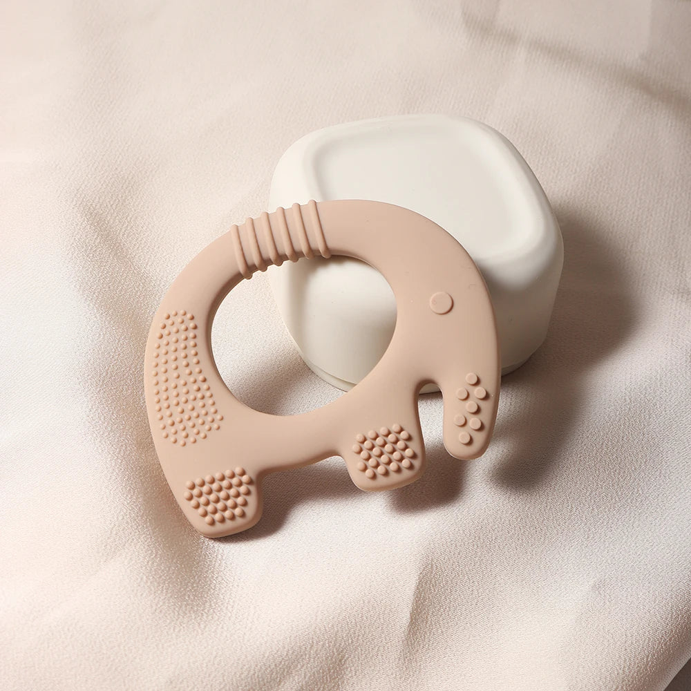 Beige silicone elephant baby teething toy for soothing sore gums.