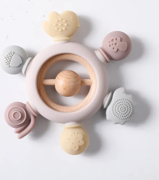 Multi-colored silicone and natural wood baby teething ring toy for infant pain relief.