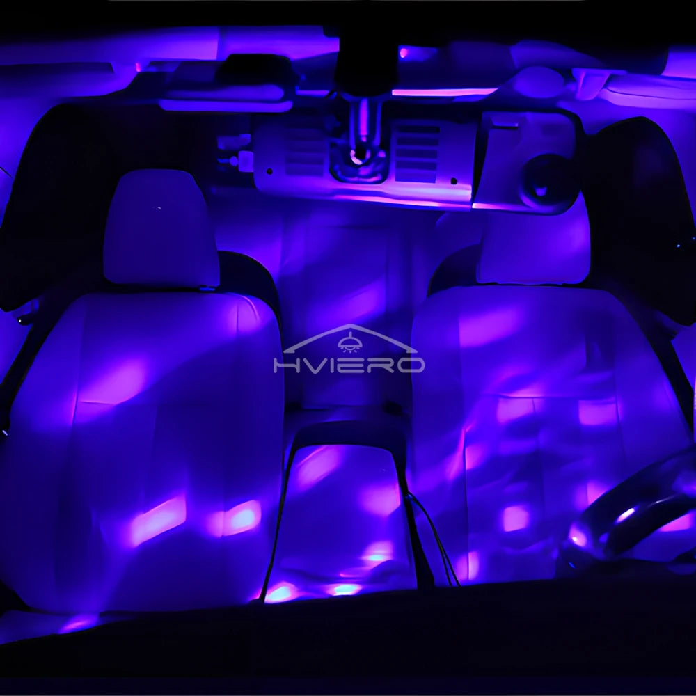 Purple LED car interior lights casting a wavy glow over front seats and vehicle dashboard.