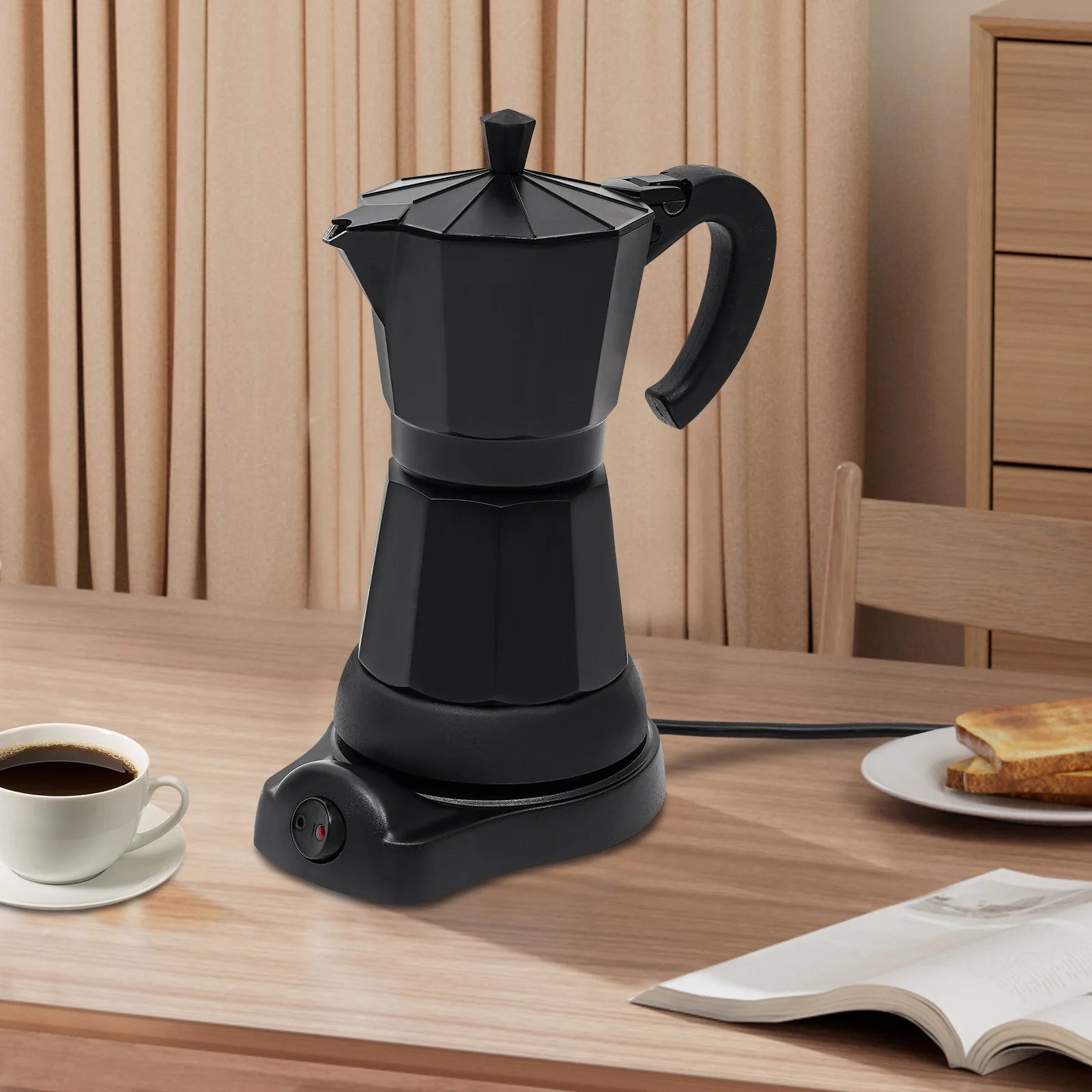 Matte black electric moka pot coffee maker on a charging base, stylish design for home espresso brewing.