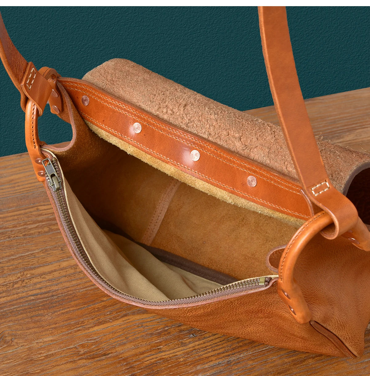 Vintage handmade tan leather messenger bag, genuine cowhide shoulder bag with rivet details and zippered interior.