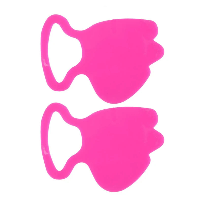 Two bright pink, ear-loop style silicone facial patches with an abstract, contoured shape isolated on white.