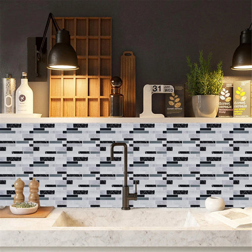Kitchen wall covered with self-adhesive 3D mosaic tile stickers in gray and blue bricks.