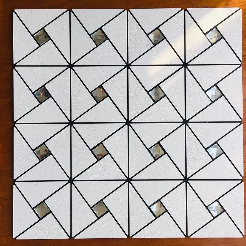 Self-adhesive mosaic tile sheet with white triangles, black lines, and reflective insets