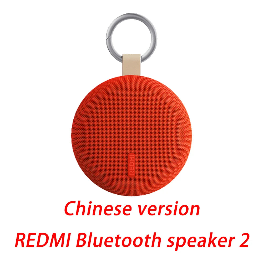 Round Bluetooth speaker with keyring, orange mesh body