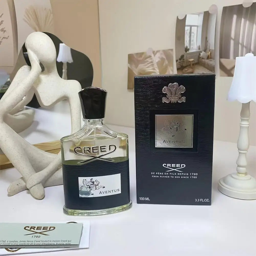 Aventus 100ml perfume bottle with black cap and matching black box on a white surface.