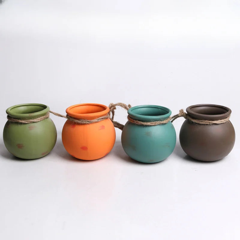 Set of 4 ceramic hanging flowerpots, green, orange, teal, and dark gray
