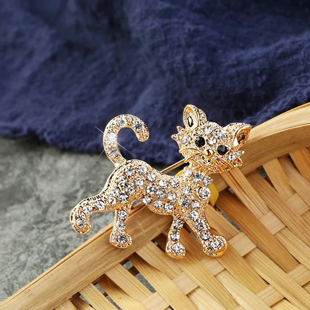Gold-tone crystal cat brooch pin for sweaters and bags. Sparkling rhinestone feline jewelry gift for cat lovers.