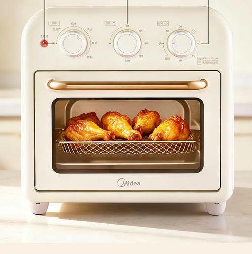 Midea air fryer oven toaster with open glass door and wire basket holding cooked chicken