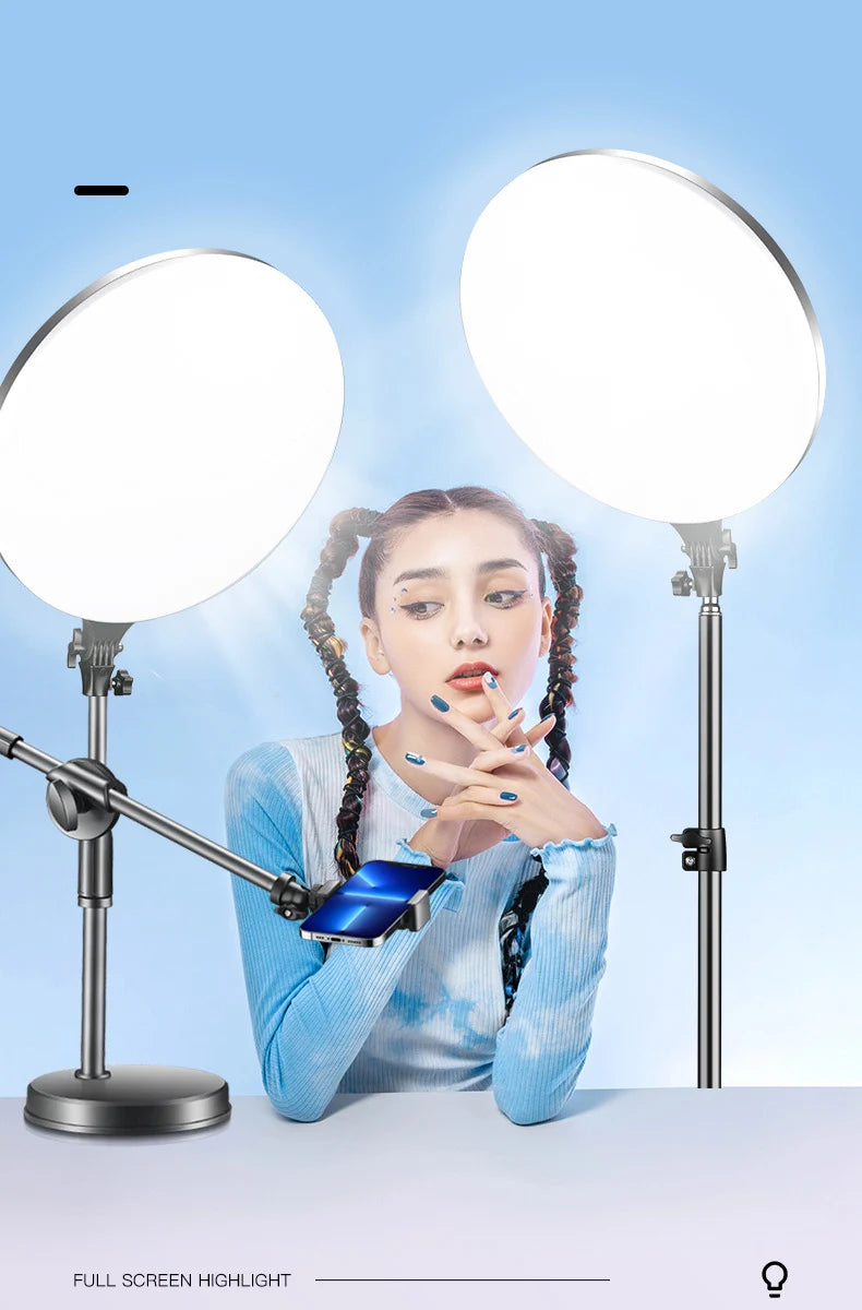 Two large, circular LED panel lights on metal stands with an adjustable smartphone holder for studio photography.