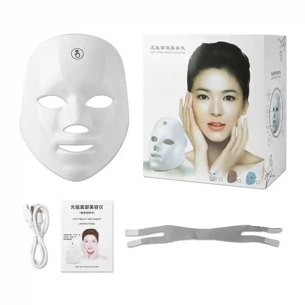 Glossy white LED facial rejuvenation mask with box, charging cable, user manual, and adjustable elastic head strap.