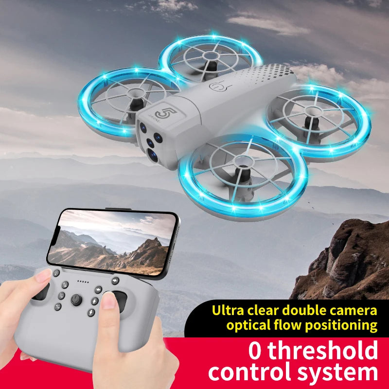 Small gray drone with four protected blue-lit propellers, dual camera, and remote controller with phone mount.