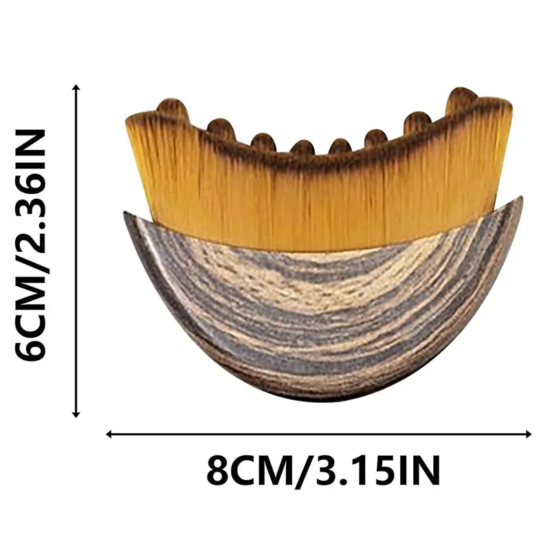 Crescent-shaped facial brush with wooden-grain handle and soft golden bristles, measuring 8cm by 6cm.