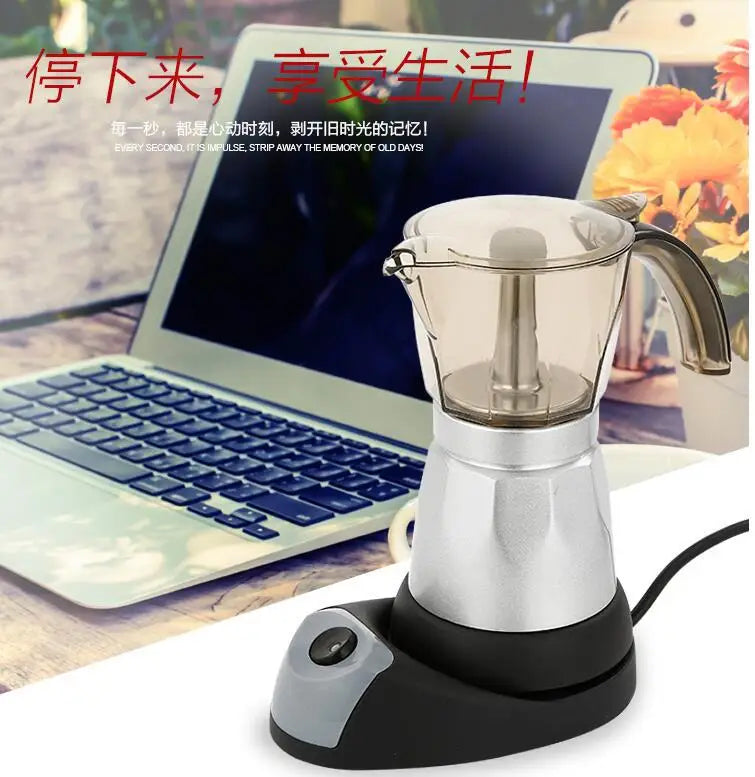 Electric silver and clear moka pot coffee maker on a black base, designed for office or home desk use.