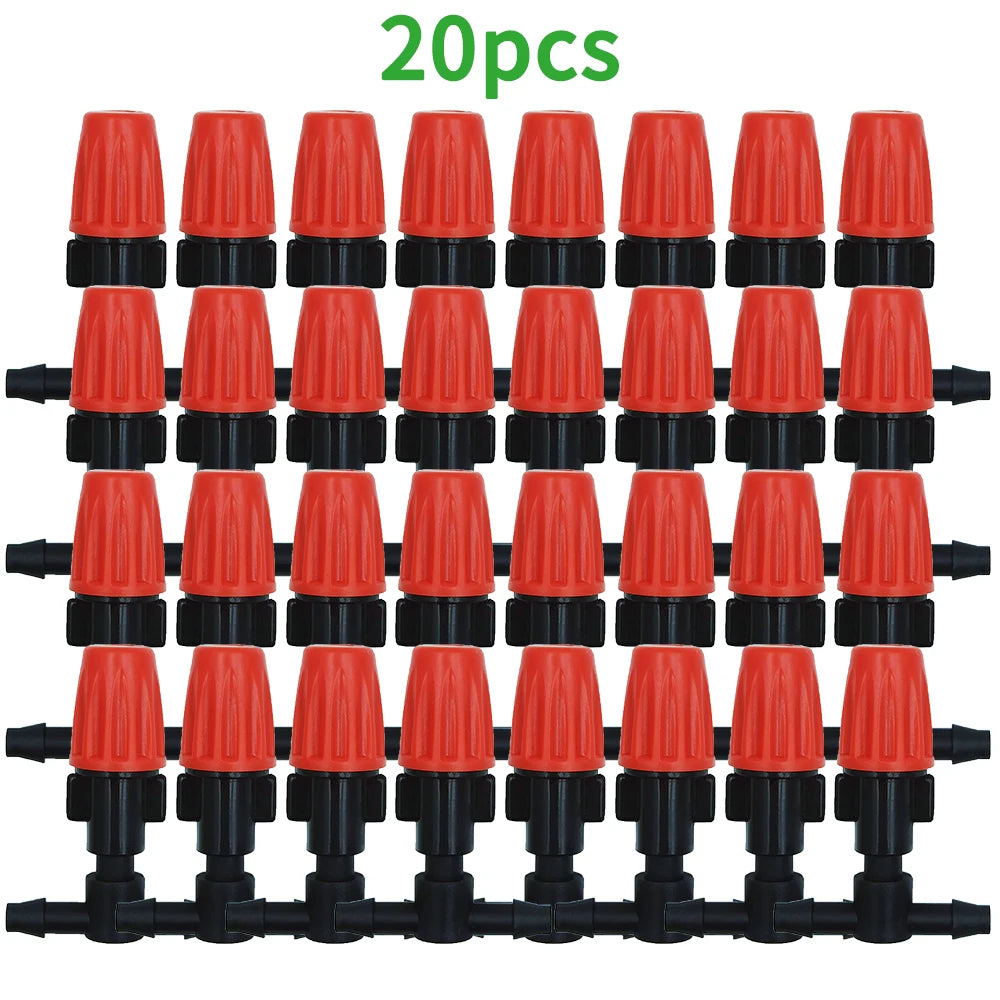 Orange drip irrigation nozzle drippers with black connectors arranged in a row